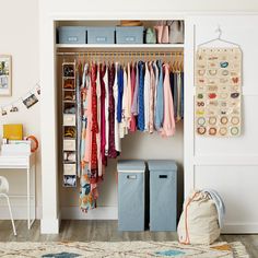 an organized closet with clothes and storage bins