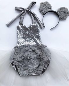 a dress made out of silver sequins and tulle with bows on the headband