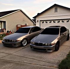 two cars parked next to each other in front of a house