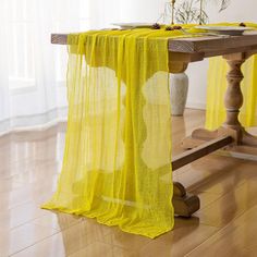 a table with a yellow cloth draped over it