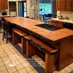 a kitchen island made out of wood in the middle of a room