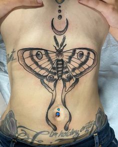 a woman with a butterfly tattoo on her stomach