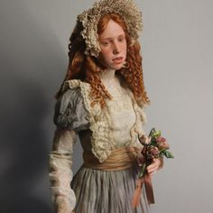 a woman with red hair wearing a white dress and holding a flower