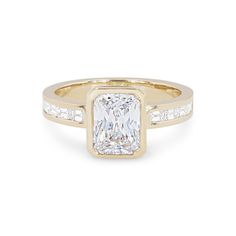 a yellow gold ring with a princess cut diamond