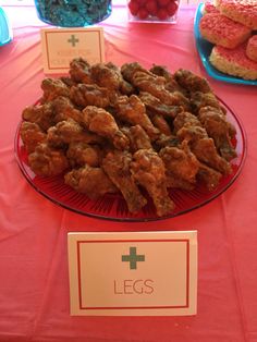 a table topped with lots of food on top of a red table cloth