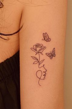 a woman's arm with flowers and butterflies on it