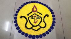 a yellow and blue cake with a face drawn on the top is surrounded by circles