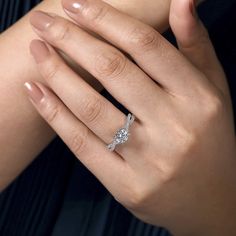 a woman's hand with a diamond ring on it