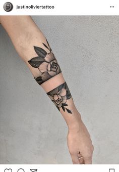 a black and white flower tattoo on the arm