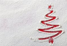 a red and white christmas tree drawn in the snow on a white background stock photo