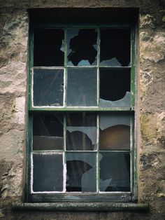 an old window with broken glass on the outside