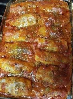 a casserole dish with meat and cheese in it sitting on top of the stove