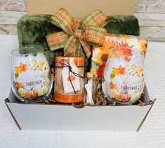 a gift box filled with candles and other items