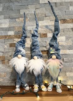 two gnomes dressed in jeans and white hair are upside down