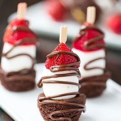 chocolate desserts with strawberries are on a white plate