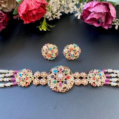 Featured is a 22k gold choker necklace set in navratna colors, designed in an fusion of the modern and the traditional. The necklace weighs 30.45 gms (including 8.5 gms in stringing). The studs weigh 8.15gms. Festive Multicolor 22k Gold Bridal Necklace, Multicolor 22k Gold Temple Necklace For Festivals, Multicolor 22k Gold Bridal Necklace For Wedding, Multicolor 22k Gold Necklace For Diwali, Multicolor 22k Gold Fusion Jewelry, Multicolor 22k Gold Kundan Temple Jewelry Necklace, Multicolor 22k Gold Kundan Necklace For Celebration, 22k Gold Multicolor Chandbali Jewelry, Festive 22k Gold Multicolor Jewelry