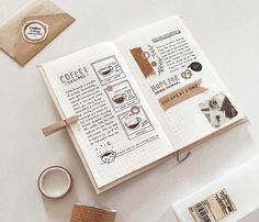 an open notebook with coffee related items on it