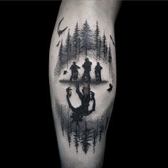 a man's leg with an image of people in the woods and birds flying around