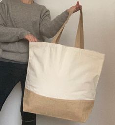 This Extra large holdall / shopper tote / beach bag is perfect to complete all relaxed, BoHo looks. Sturdy yet stylish, you will want to take it everywhere! █ SIZE: CM 56 x 44 x 17 (INCHES 22 x 17.5 x 7). █ the HANDLES measure CM 63 (INCHES 25). █ Made of natural cotton with a jute base. █ Gorgeously natural oatmeal colour █ READY TO SHIP - I use ROYAL MAIL secure services and provide a tracking number after shipping. █ TYPICAL DELIVERY TIMES: EUROPE: 4 to 7 days NORTH AMERICA and RUSSIA: 6 to 1 Eco-friendly Cream Beach Bag, Eco-friendly Beige Cotton Beach Bag, Beige Cotton Bags For Beach Season, Beige Cotton Bag For Beach Season, Eco-friendly Cream Tote Beach Bag, Natural Canvas Tote Bag For Beach Season, Eco-friendly Canvas Beach Tote Bag, Eco-friendly Canvas Tote Bag For Beach Season, Eco-friendly Canvas Beach Tote