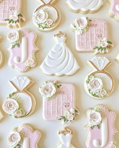 decorated cookies are arranged in the shape of wedding gowns and grooms on display