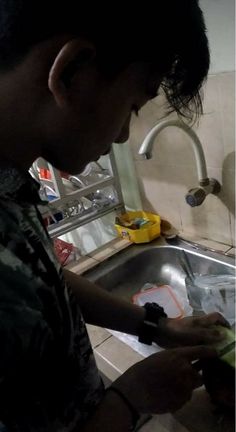 a man is washing his hands in the sink