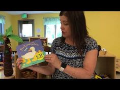 a woman reading a children's book in a library