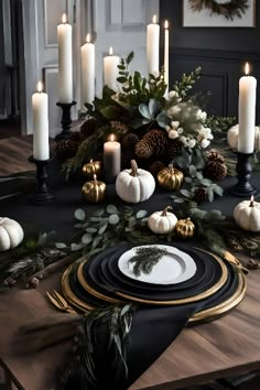 a dining room table with candles, plates and other holiday decorations on top of it