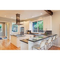 a kitchen with an island and stove top oven