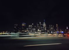 the city skyline is lit up at night