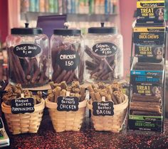 several jars filled with dog treats on top of a counter