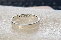 a silver ring with the word i love you written in cursive writing on it