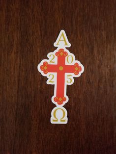 a wooden table topped with a cross sticker on top of it's side