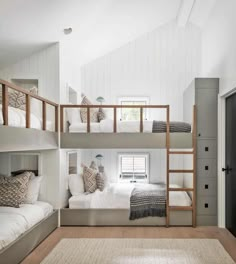 a bedroom with bunk beds and white walls