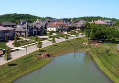 an aerial view of a lake in the middle of a neighborhood