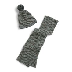 two knitted hats and scarfs sitting on top of a white surface with the same color