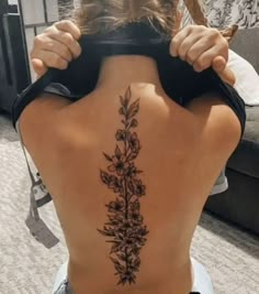 the back of a woman's body with flowers on it