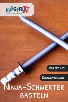 two pens sitting next to each other on top of a wooden table in front of an ausgefix logo