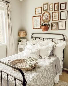 a bed with white sheets and pillows in a bedroom next to a basket filled with flowers