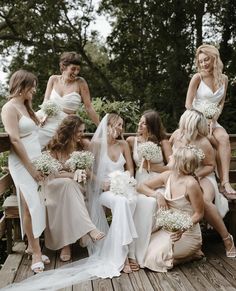 a group of bridesmaids sitting on a wooden deck