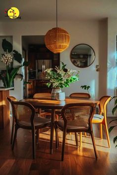 a dining room table with chairs and a vase filled with flowers sitting on top of it