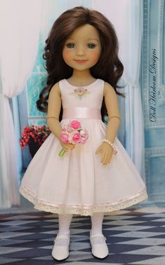 a doll with long brown hair wearing a white dress and pink flowers in her hand