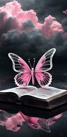 a pink butterfly sitting on top of an open book in front of a cloudy sky