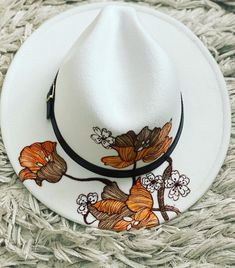 Jolie Tete or "pretty head" are Hats with a retro boho vibe. Each one is individually hand painted and unique to each purchase. What you see in the photo is something I can recreate and paint for you but may be slightly different since it's a unique work of art.  65% Cotton/35% Polyester Buckle closure MATERIAL: 65% Cotton, 35% Polyester, Soft and Comfortable to Wear. SIZE:One Size Fit All Most Women Men. Hat Circumference:56-58cm/22-22.8" ; Brim. There is an adjustable sizer inside the hat for White Hand Painted Flat Brim Hat, Hand Painted White Brimmed Hat, Custom Handmade White Fedora, Artistic Fedora For Spring Festival, Custom White Handmade Fedora, Handmade White Fedora For Spring, Bohemian Hand Painted Hats For Spring, White Artisan Hand Painted Hats, Artistic Hand Painted Fedora For Festivals