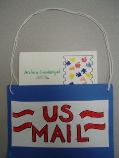 a us mail bag hanging on the wall with an envelope attached to it that says us mail