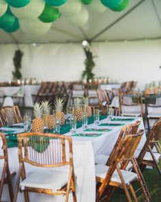 tables set up with pineapples and green napkins