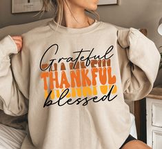 Grateful Thankful Blessed Sweater - Gift For Thankful Day - Fall Lover Sweater - Autumn Hoodie - Thanksgiving Sweater - Fall Season Hoodie Description How can I order? 1️) Please review all the information provided before placing an order 2️) Select the shirt type and size. 3️) Select the color of the shirt using the following options. 4️) Need more Items? Add the current item in the cart. And If you like to add more items to your order please press the back button and repeat steps 1-4 again. 5️ Long Sleeve Hoodie With Lettering For Fall, Hooded Fall Sweatshirt With Lettering, Hooded Sweatshirt With Lettering For Fall, Cricut Sweatshirt Ideas, Autumn Hoodie, Sweatshirt Ideas, Thanksgiving Sweater, Sweater Autumn, Cute Shirt Designs