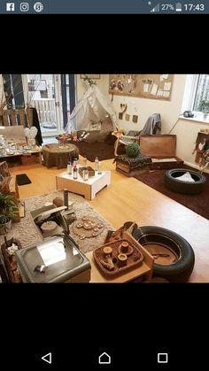 a living room filled with furniture and lots of clutter on top of a hard wood floor