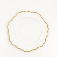 a white plate with gold trim on the edge against a white background that looks like it has been made out of porcelain