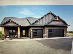 a large house with two garages on the front and one attached to the side