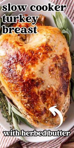 a close up of a chicken on a plate with text overlay that reads slow cooker turkey breast with herb butter